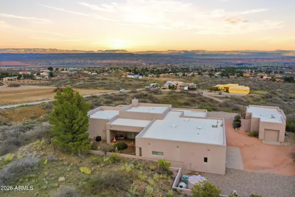 a bedroom with a bed and a flat tv screen on dresser