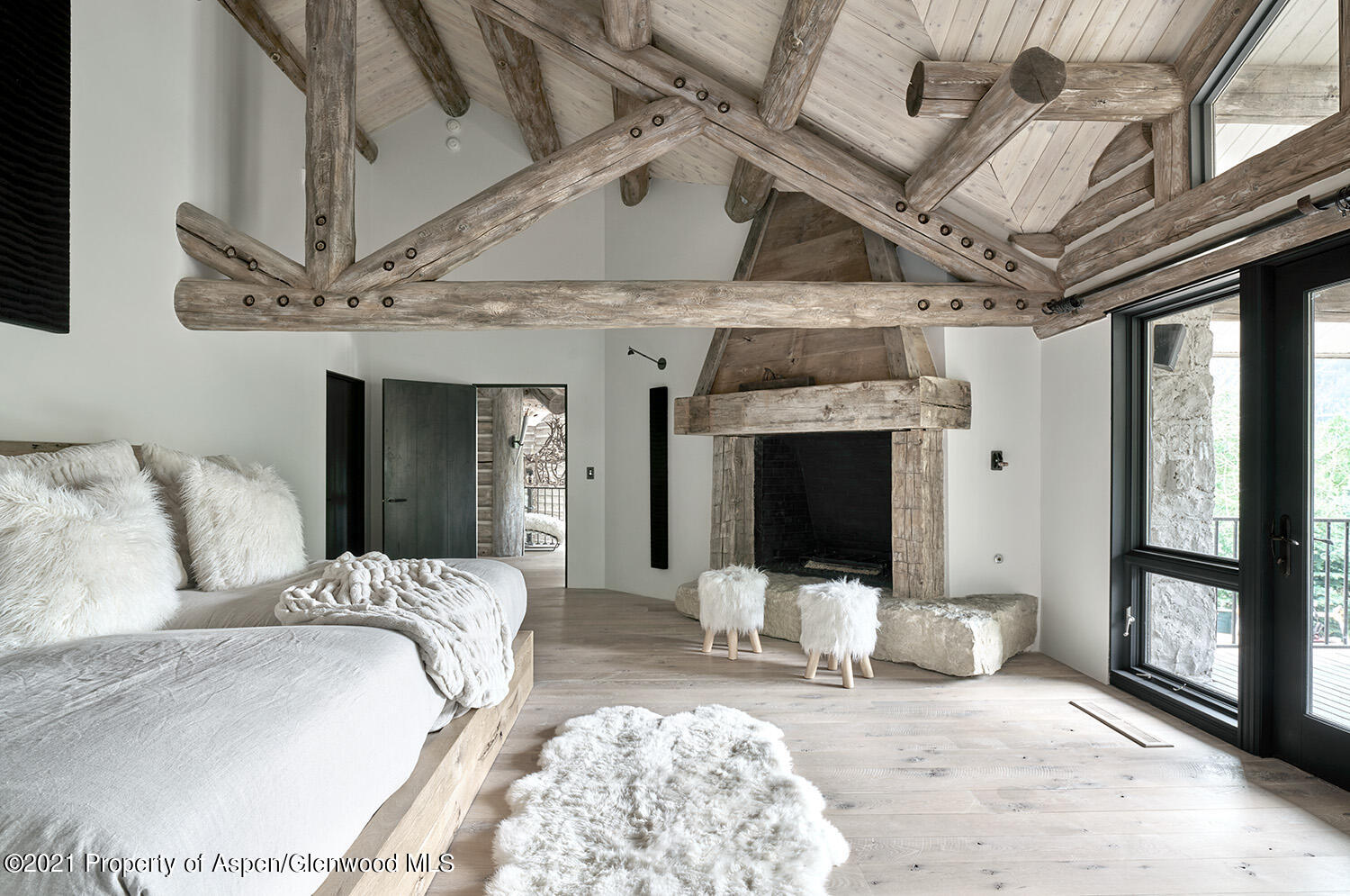 931 North Hayden Road Aspen, CO 81611 - Photo 12 of 44 a bed room with a bed tv and a fireplace