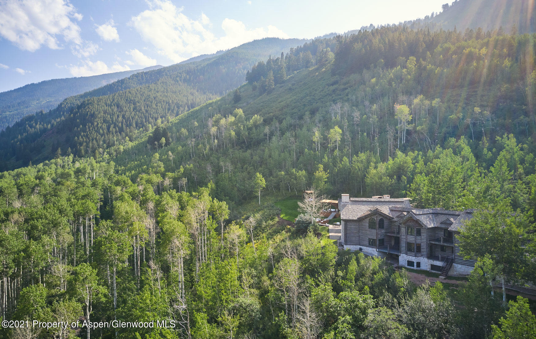931 North Hayden Road Aspen, CO 81611 - Photo 20 of 44 a view of a house with a yard and a wooden fence