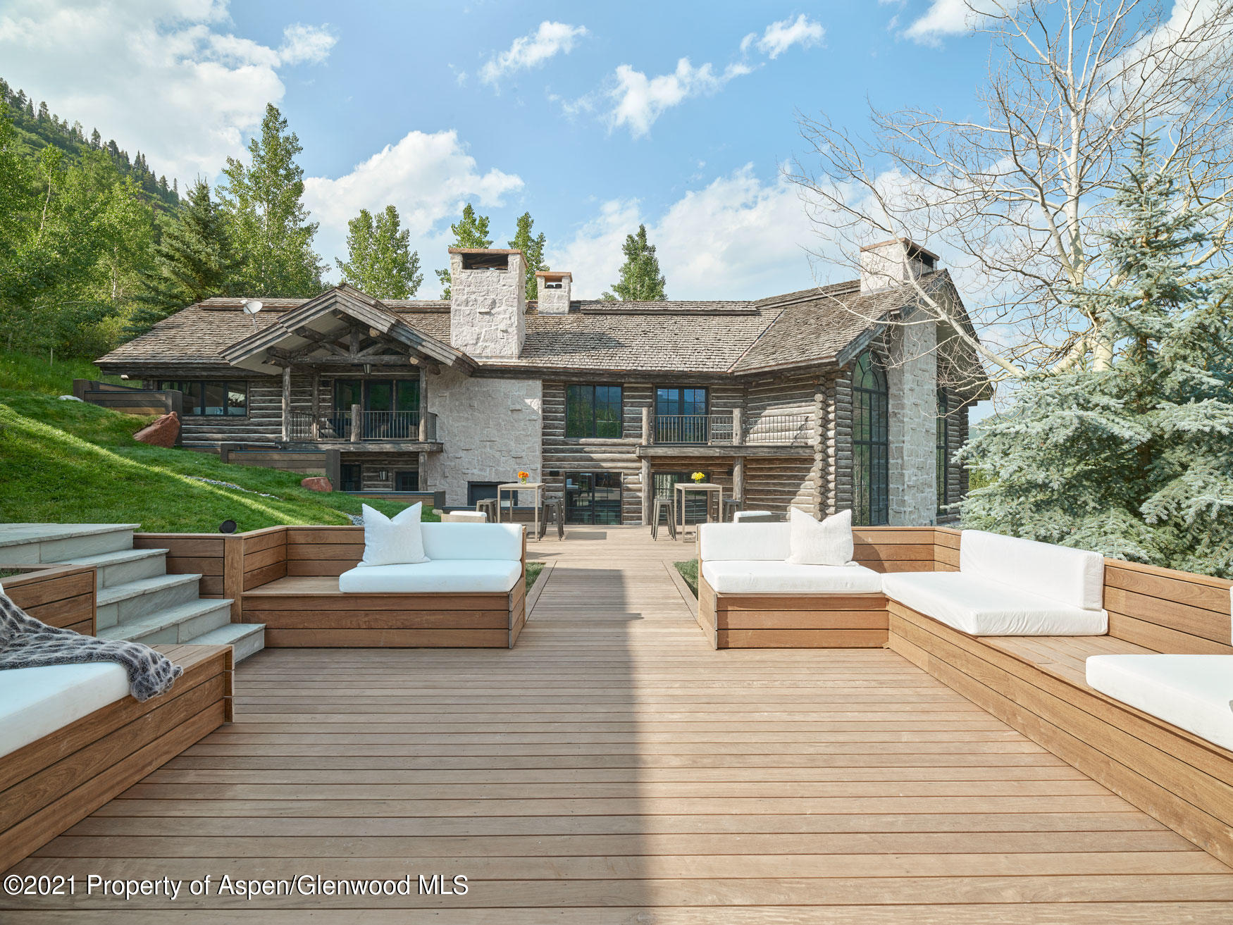 931 North Hayden Road Aspen, CO 81611 - Photo 24 of 44 a view of a patio with couches and table and chairs with wooden floor and fence