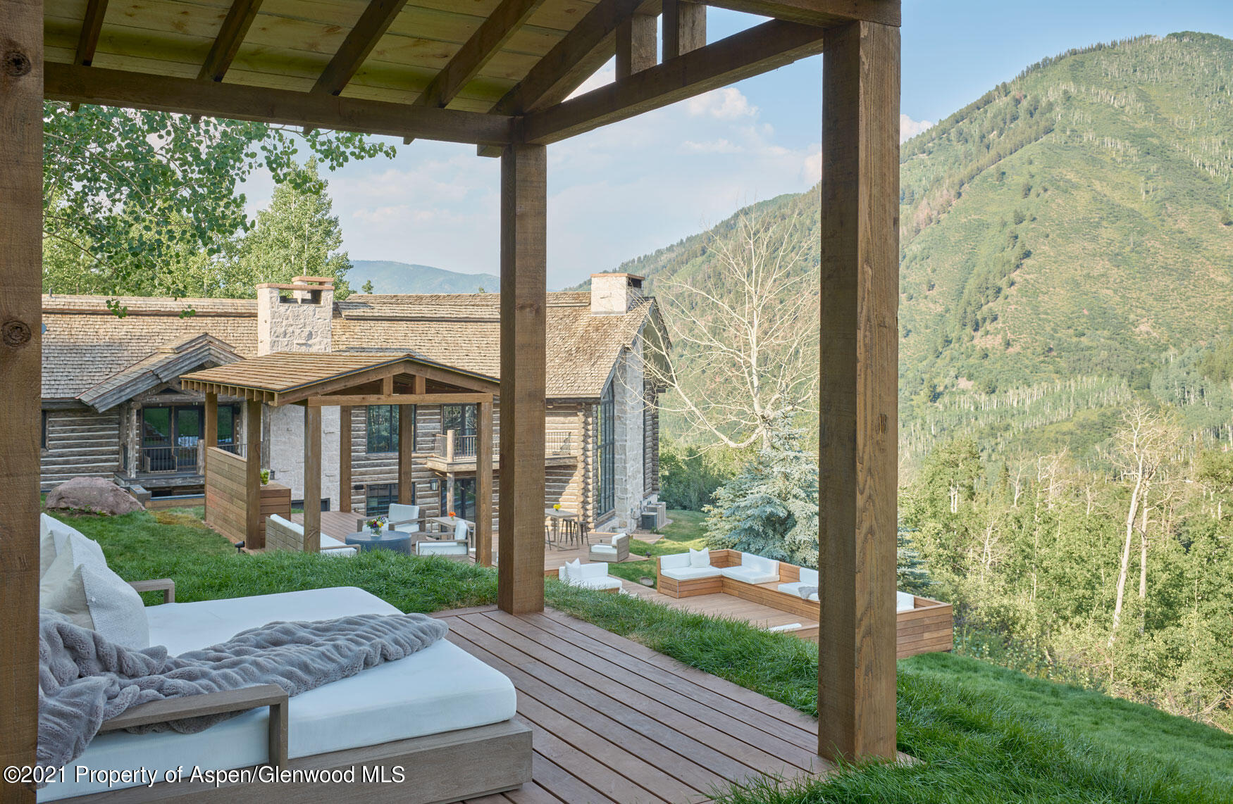 931 North Hayden Road Aspen, CO 81611 - Photo 26 of 44 a view of a patio with a table chairs and a yard
