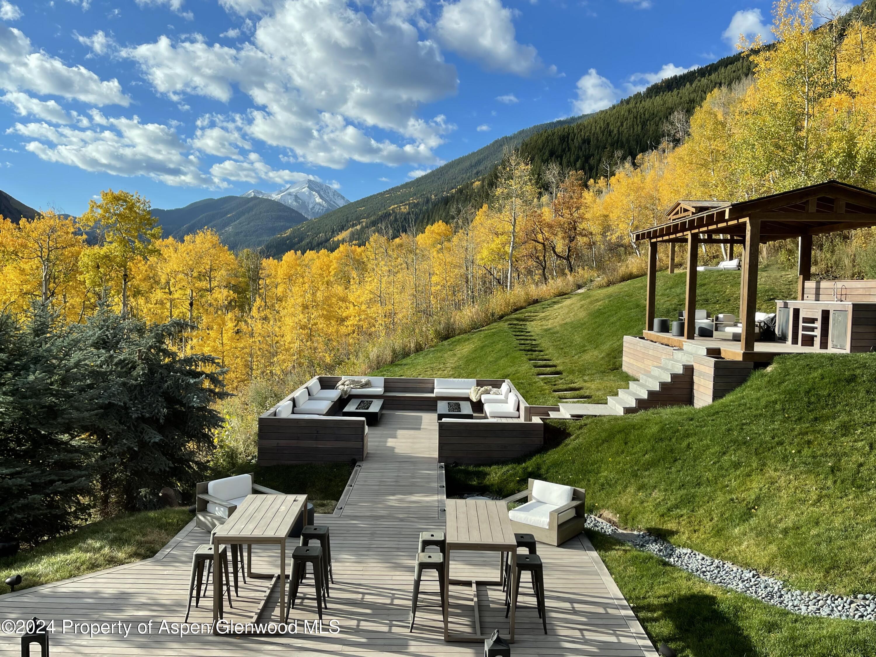 931 North Hayden Road Aspen, CO 81611 - Photo 38 of 44 a roof deck with table and chairs and potted plants
