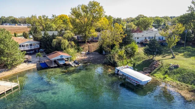 an aerial view of a house with a yard basket ball court and outdoor seating