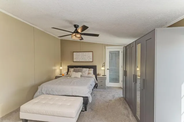 a bedroom with a bed and a chandelier