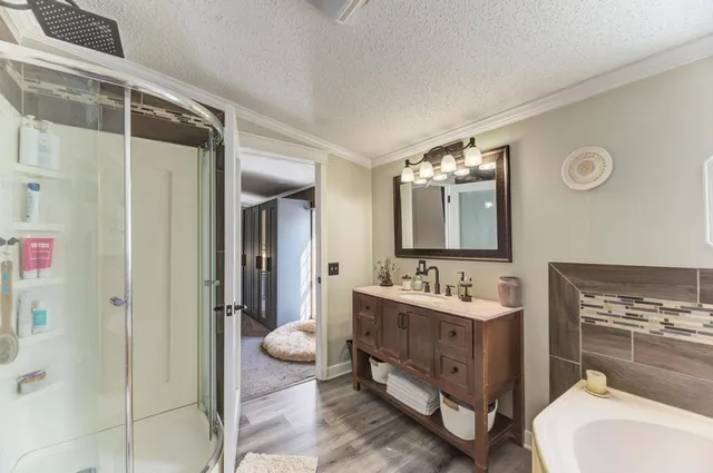 a bathroom with a double vanity sink mirror and shower