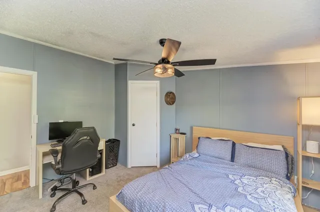 a bedroom with a bed and a desk