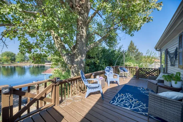 a balcony with wooden floor and outdoor seating