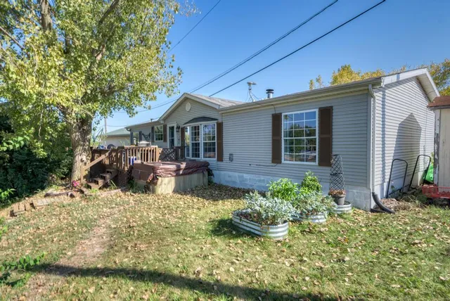 a view of a house with backyard outdoor seating area