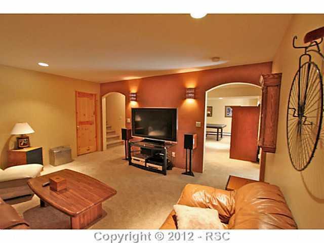 16 West Point Road Colorado Springs, CO 80906 - Photo 16 of 25 The basement features a theater room complete with Santa-fe style lighting, plush carpeting. Again, there is a built-in stereo system throughout the home. An additional family room, full bath and large bedroom is also located in the basement area