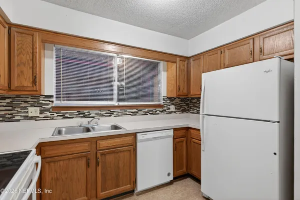 an empty room with a window and a ceiling fan