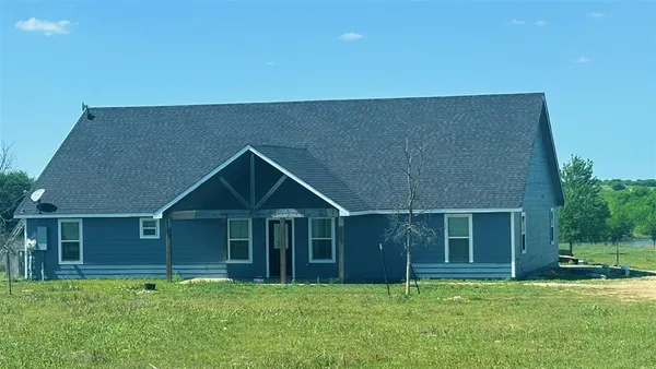 a big house with potted plants in front of it