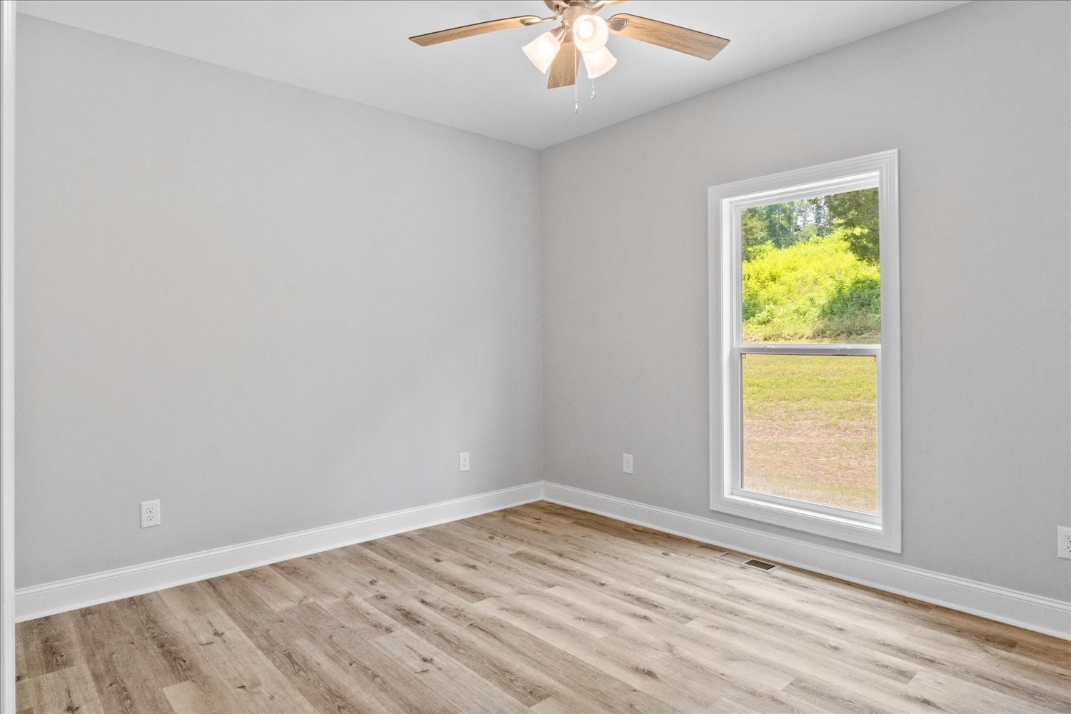 763 Potter Road Dickson, TN 37055 - Photo 14 of 23 a view of an empty room with wooden floor and a window