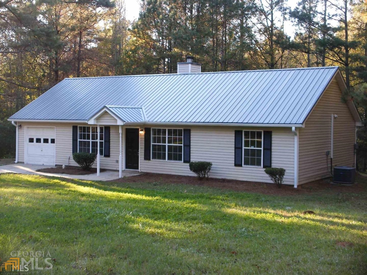 717 Oakland Road Gay, GA 30218 - Photo 1 of 1 a view of a house with a yard potted plants and large tree