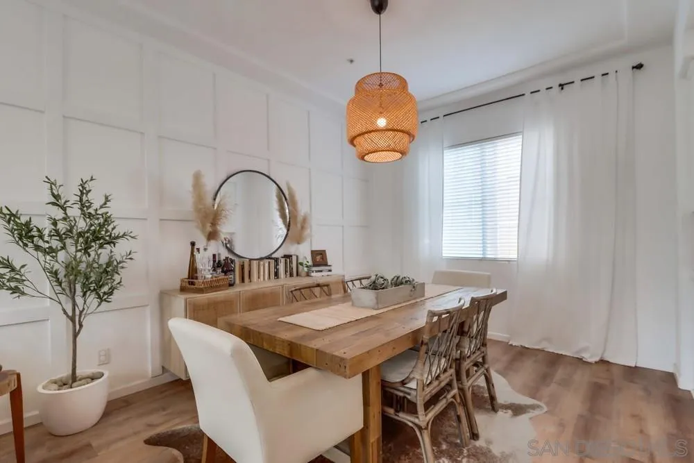 2221 Historic Decatur Road, Unit 61 San Diego, CA 92106 - Photo 12 of 29 a dining room with chandelier fan and wooden floor