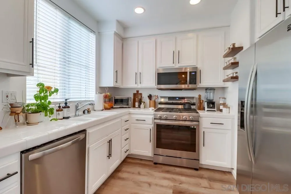 2221 Historic Decatur Road, Unit 61 San Diego, CA 92106 - Photo 15 of 29 a kitchen with a white stove top oven and refrigerator