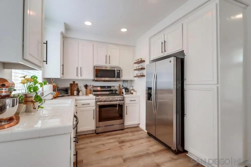 2221 Historic Decatur Road, Unit 61 San Diego, CA 92106 - Photo 16 of 29 a kitchen with cabinets stainless steel appliances and a counter space