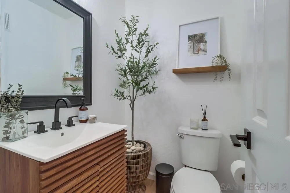 2221 Historic Decatur Road, Unit 61 San Diego, CA 92106 - Photo 19 of 29 a bathroom with a sink toilet and a mirror