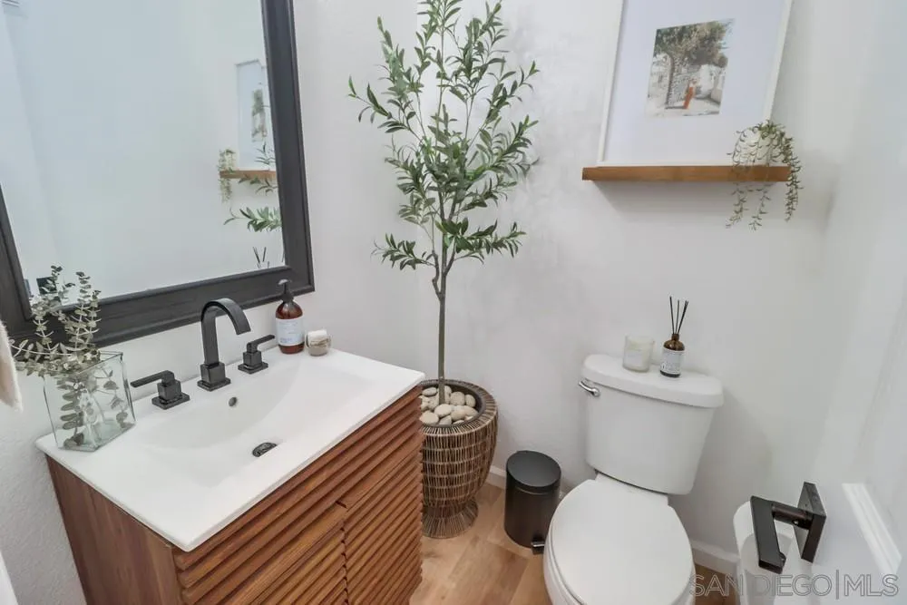 2221 Historic Decatur Road, Unit 61 San Diego, CA 92106 - Photo 20 of 29 a bathroom with a sink a toilet and a mirror