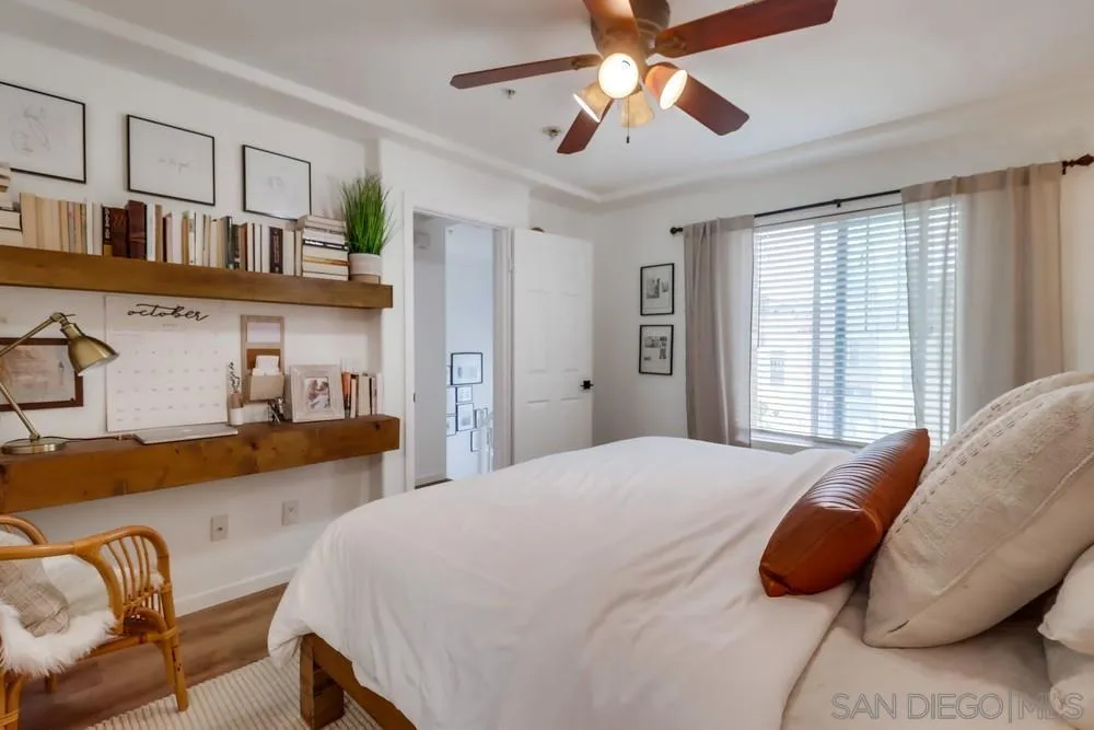 2221 Historic Decatur Road, Unit 61 San Diego, CA 92106 - Photo 26 of 29 a bedroom with a bed and wooden floor
