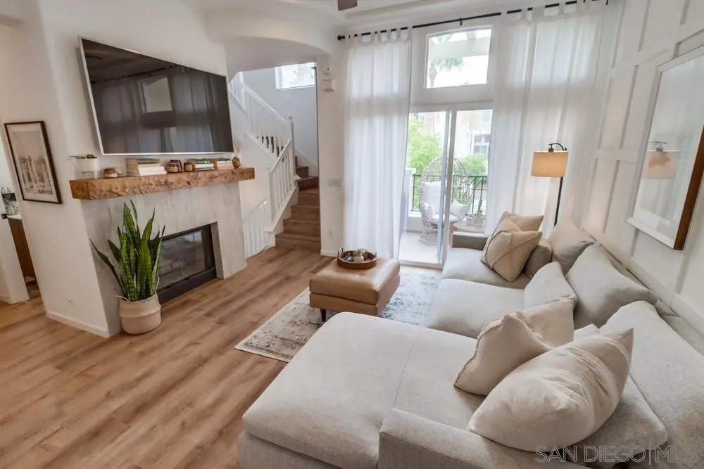 2221 Historic Decatur Road, Unit 61 San Diego, CA 92106 - Photo 6 of 29 a living room with furniture flat screen tv and a large window