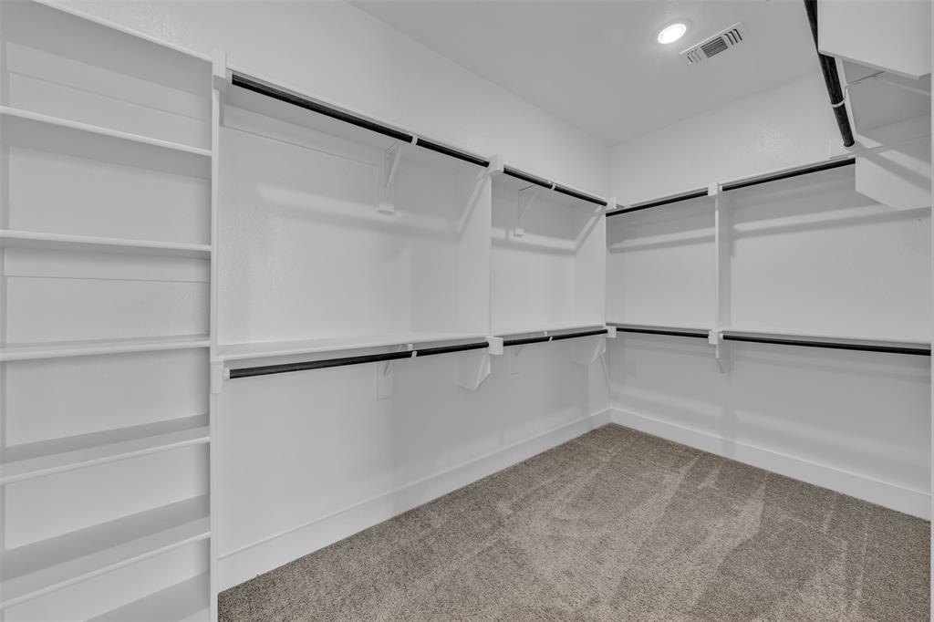 2004 Willy Dilly Road Springtown, TX 76082 - Photo 30 of 40 Walk-in closet featuring built-in shelving, multiple hanging rods, white walls, and a recessed ceiling light