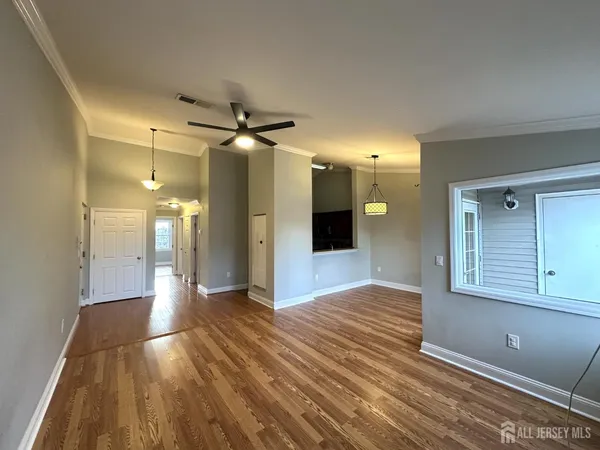 a view of a hallway with wooden floor