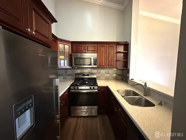 a kitchen with a sink stove and microwave