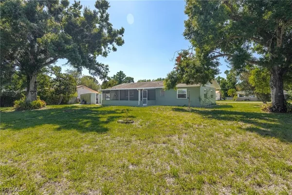a front view of house with yard and trees