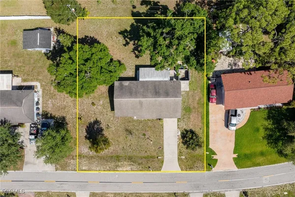 an aerial view of a house with a yard and plants
