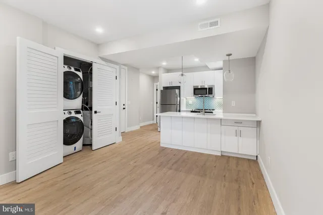 a view of a kitchen with counter top space cabinets and stainless steel appliances