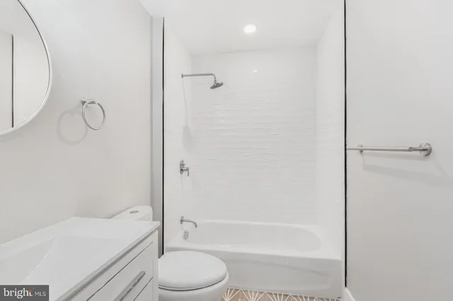 a bathroom with a bathtub a toilet and a shower