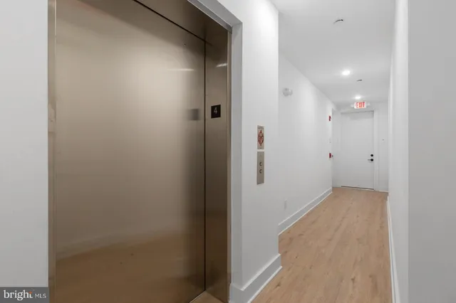 a view of hallway with wooden floor