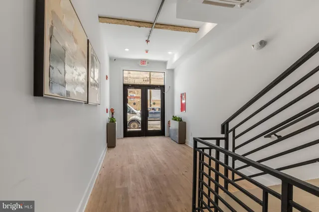 a view of entryway and hall with wooden floor