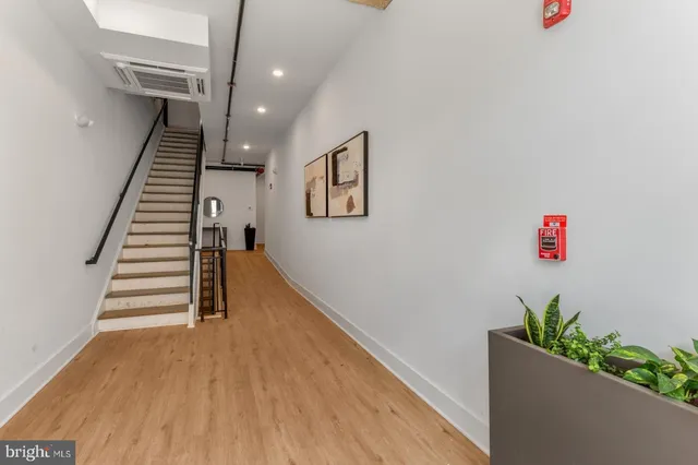 a view of entryway and hall with wooden floor