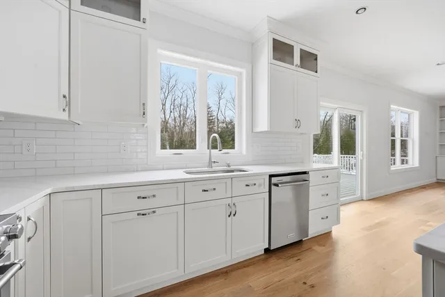 a kitchen with granite countertop white cabinets and white appliances