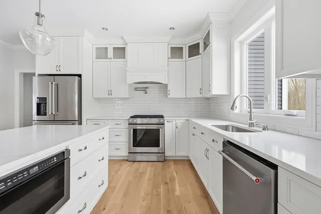 a kitchen with granite countertop a sink stove and cabinets