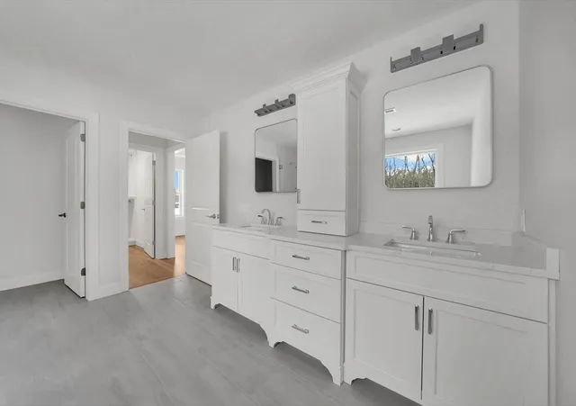 a bathroom with a double vanity sink and mirror