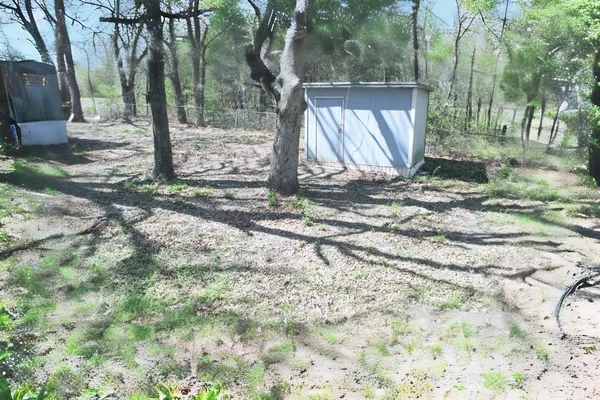 a wooden fence with a trees in the background