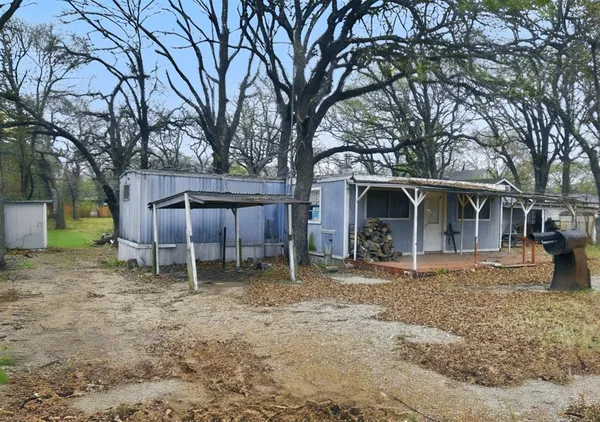 a backyard of a house with table and chairs