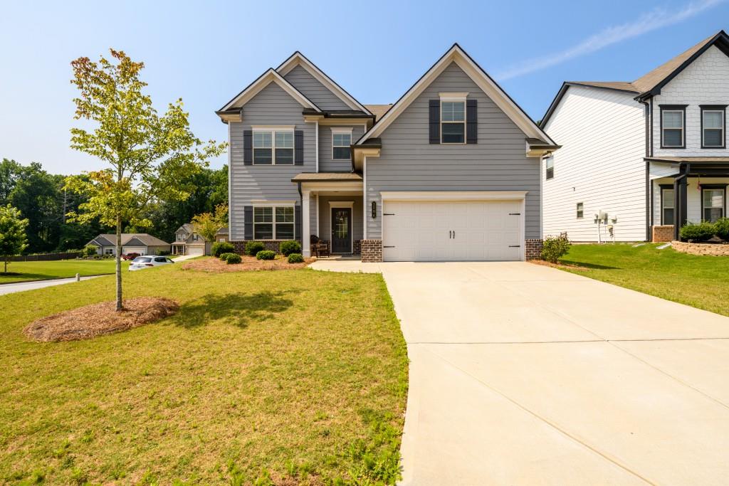 a front view of a house with a yard