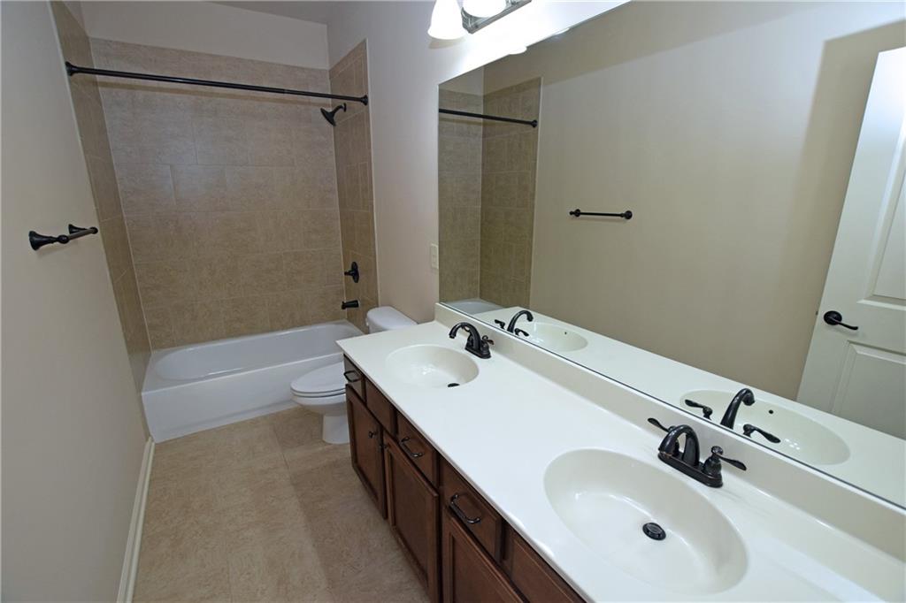 1630 Bramble Bush Way Suwanee, GA 30024 - Photo 22 of 31 a bathroom with a sink and a mirror