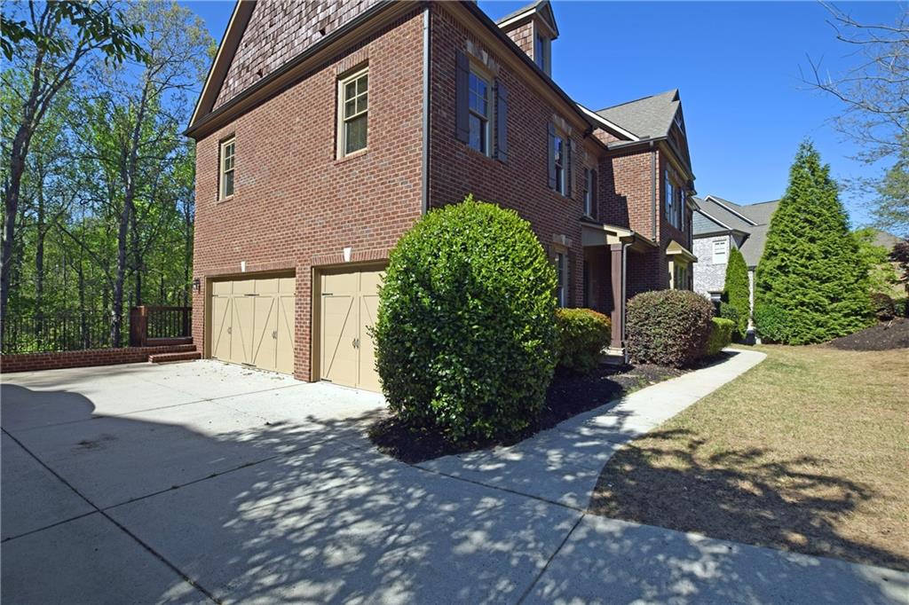 1630 Bramble Bush Way Suwanee, GA 30024 - Photo 28 of 31 a view of a house with a yard
