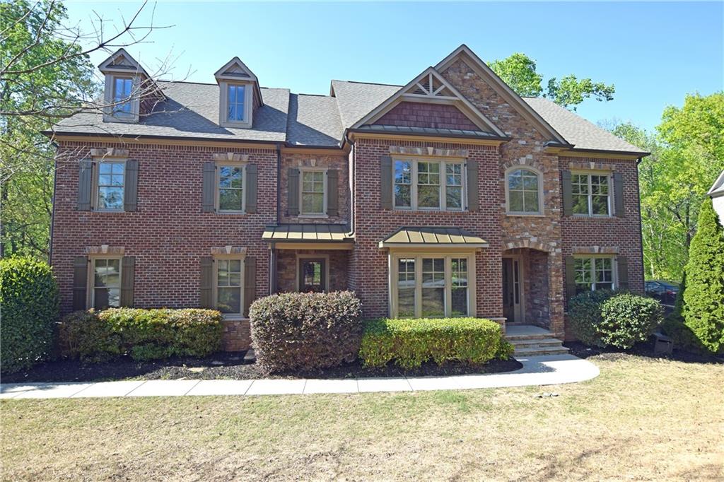 1630 Bramble Bush Way Suwanee, GA 30024 - Photo 29 of 31 a front view of a house with yard and green space