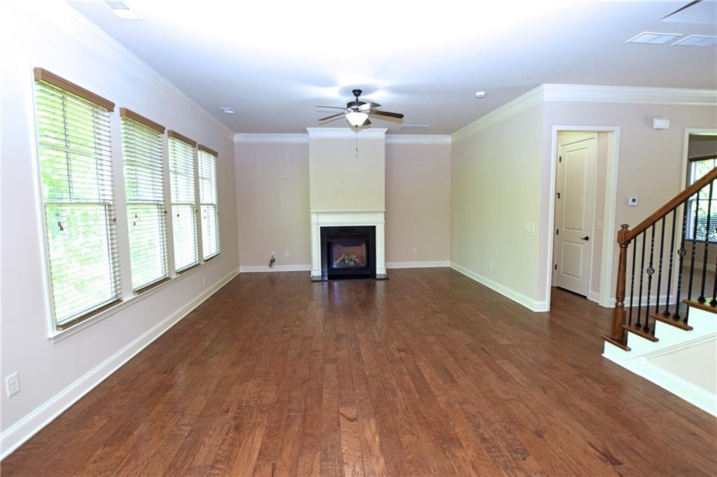 1630 Bramble Bush Way Suwanee, GA 30024 - Photo 6 of 31 wooden floor in an empty room with a window