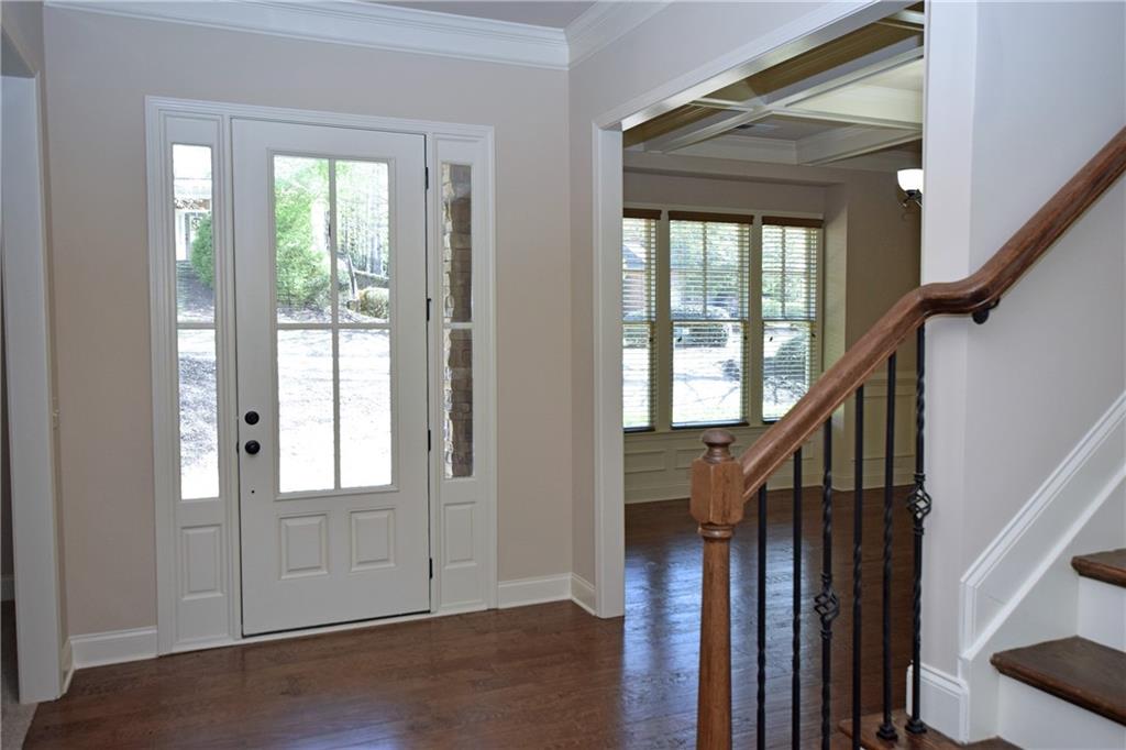 1630 Bramble Bush Way Suwanee, GA 30024 - Photo 8 of 31 a view of front door with hallway and wooden floor