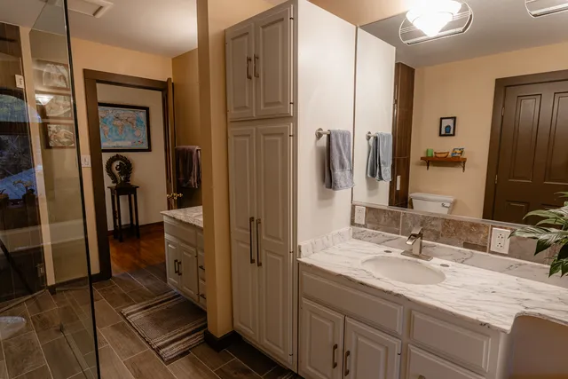 a view of a hallway with wooden floor and stairs