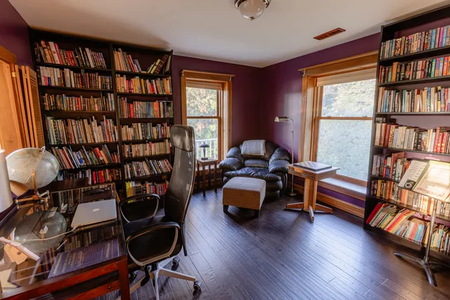 a living room with furniture and a book shelf