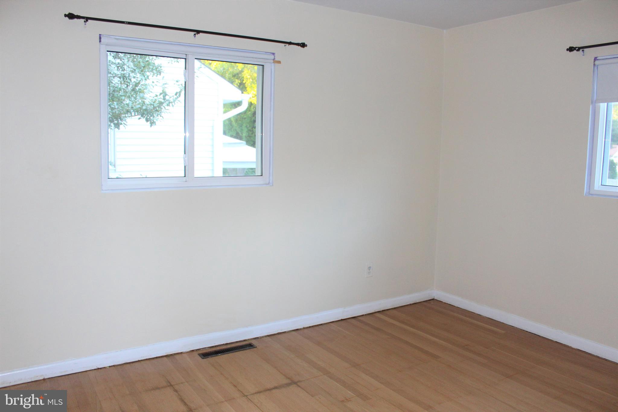 413 Dickinson Road Glassboro, NJ 08028 - Photo 10 of 16 wooden floor in an empty room with a window