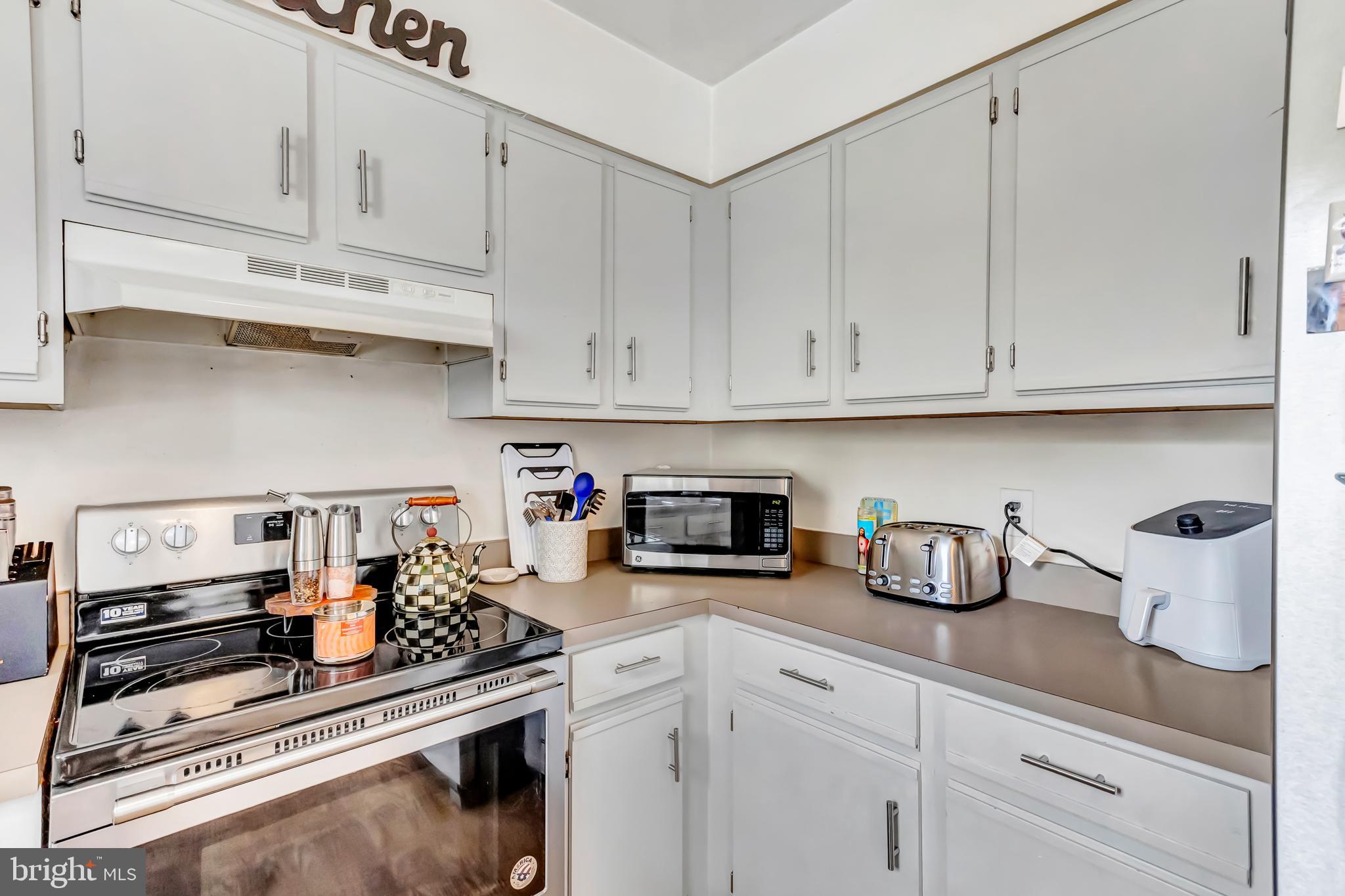 4925 Campground Road Eden, MD 21822 - Photo 9 of 42 a kitchen with white cabinets and appliances