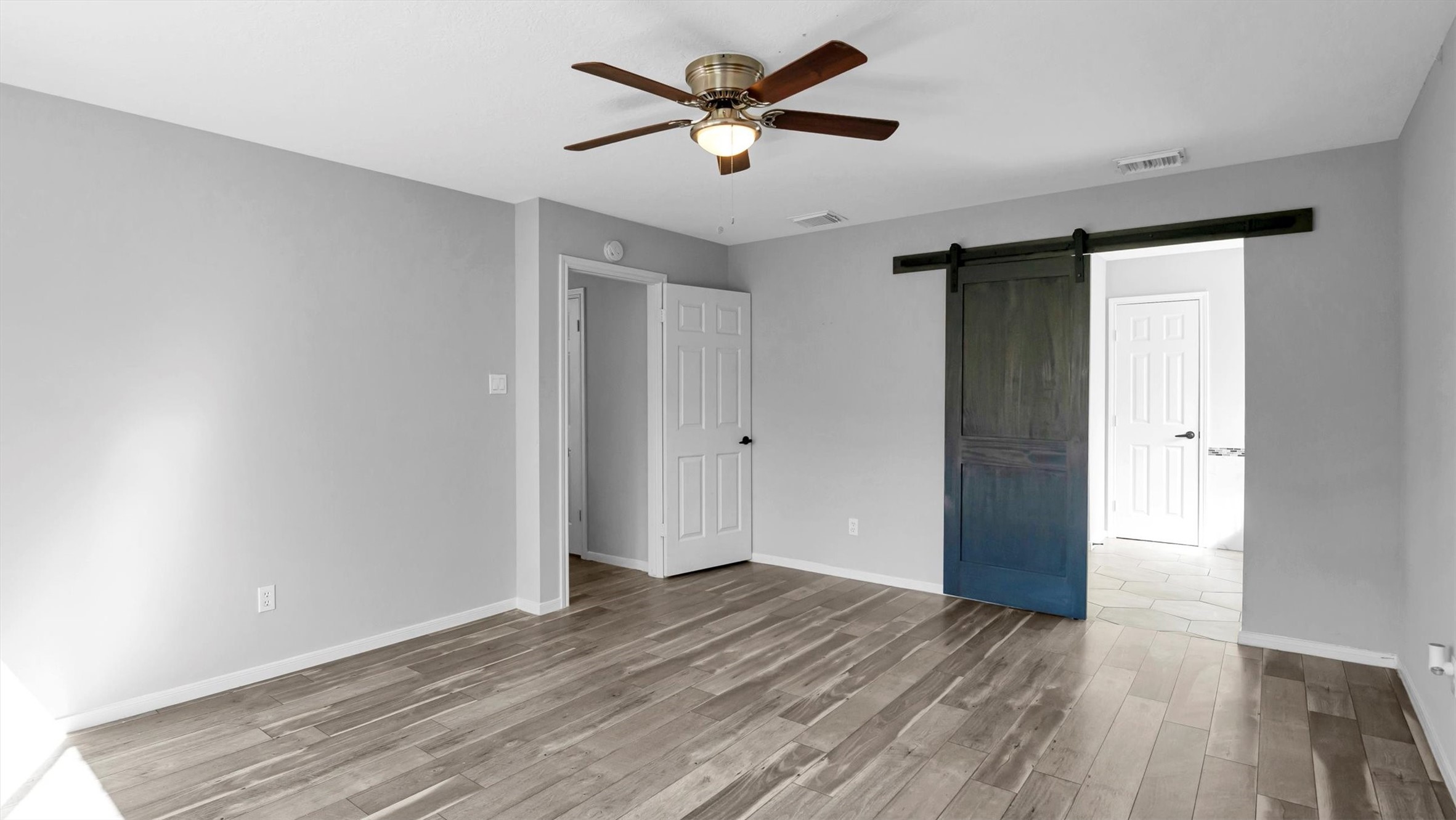 22919 Prairie Bird Lane Spring, TX 77373 - Photo 21 of 33 Primary bedroom with sliding barn doors